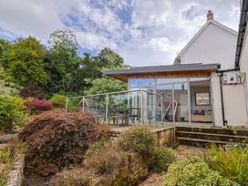 A house with a garden and deck area at The Well House in Lyme Regis