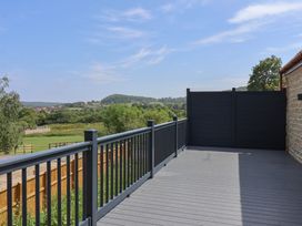 A deck area with a railing and fence at Castle View in Scarborough