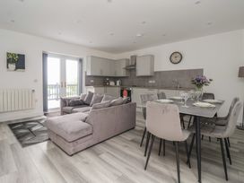 A living room with a sofa and dining area at Castle View in Scarborough