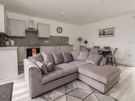 A living room with a sofa and dining area at Castle View in Scarborough