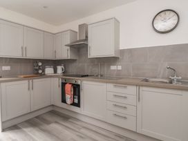 A kitchen with cabinets and appliances at Castle View in Scarborough