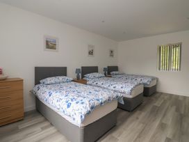 A bedroom with three beds and a dresser at Castle View in Scarborough