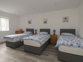 A bedroom with three beds and nightstands at Castle View in Scarborough