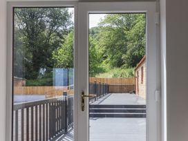 A view through a door of a deck and trees at Castle View in Scarborough