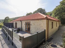 An outdoor area with a deck and chairs at Castle View in Scarborough