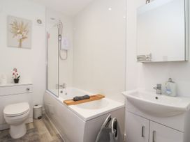 A bathroom with a bathtub and sink at Castle View in Scarborough