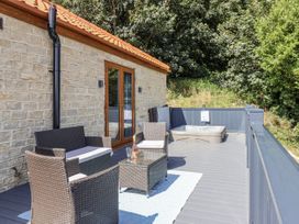 A deck with chairs and a hot tub at Castle View in Scarborough