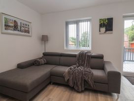 A living room with a sofa and window at Woodside in Scarborough
