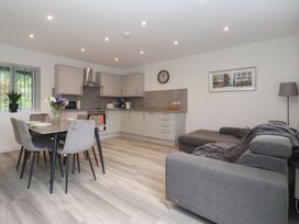 A kitchen and dining area with furniture at Woodside in Scarborough