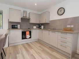 A kitchen with cabinets and appliances at Woodside in Scarborough