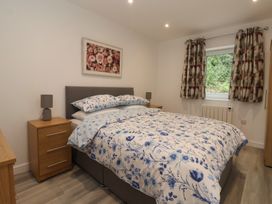 A bedroom with a bed and bedside table at Woodside in Scarborough