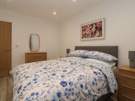 A bedroom with a bed and dresser at Woodside in Scarborough