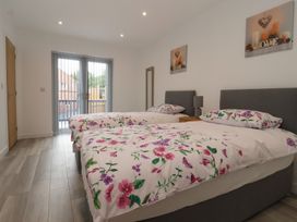 A bedroom with two beds and sliding doors at Woodside in Scarborough