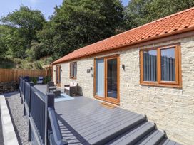 A building with a deck and furniture at Woodside in Scarborough