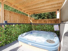 An outdoor hot tub surrounded by wooden fencing at Woodside in Scarborough