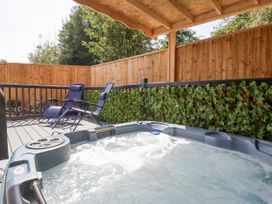 A hot tub and lounge chairs in an outdoor area at Woodside in Scarborough