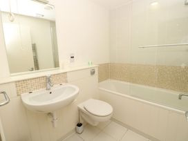 A bathroom with a sink toilet bathtub and mirror at Cape A9 Norton Near Freshwater