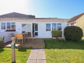 A house with a wooden deck and outdoor chairs and table in front at Cape A9 Norton Near Freshwater