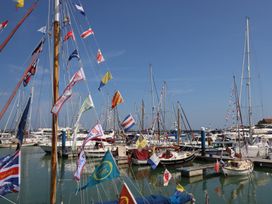 A marina with sailboats decorated with signal flags in the water at Cape A9 Norton Near Freshwater