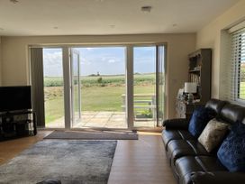 A living room with a sofa and television at Seadrift near Stalham