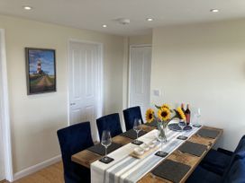 A dining room with a table set for dinner at Seadrift near Stalham