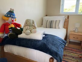 A bedroom with a bed, toys, and a nightstand at Seadrift near Stalham