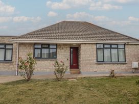 A house with a red door and garden at 7 Cedar Drive Preston