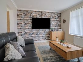A living room with a tv and coffee table at 7 Cedar Drive Preston