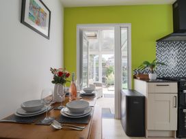 A kitchen with dining table set for a meal at 7 Cedar Drive in Preston