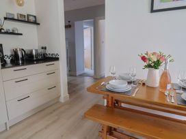 A kitchen with a dining table set for a meal at 7 Cedar Drive Preston