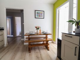 A kitchen with a dining table set for meals at 7 Cedar Drive, Preston