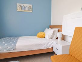 A bedroom with a bed and a lamp at 7 Cedar Drive, Preston