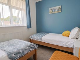 A bedroom with two beds and a window at 7 Cedar Drive in Preston