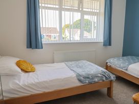 A bedroom with two beds and a window at 7 Cedar Drive Preston