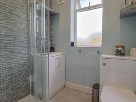 A bathroom with a shower, sink, and toilet at 7 Cedar Drive Preston