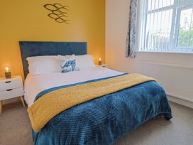 A bedroom with a bed and nightstands at 7 Cedar Drive Preston