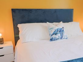 A bed with pillow and bedside table at 7 Cedar Drive Preston