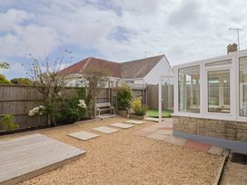 A garden with a pathway and a conservatory at 7 Cedar Drive in Preston