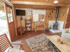A living room with a sofa and wood stove at The Lodge in 