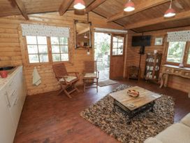 A living room with a table and chairs at The Lodge in 