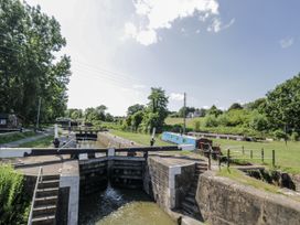 A waterway with lock gates and boats alongside a path at The Lodge in 