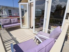 An outdoor seating area with purple furniture at 152 Central Park in Prestatyn