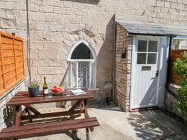 An outdoor area with a table and chairs at Driftwood in Weymouth