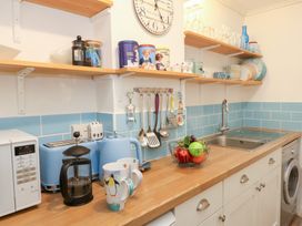 A kitchen with appliances and utensils at Driftwood in Weymouth