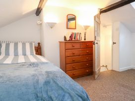 A bedroom with a bed and a dressing table at Driftwood in Weymouth