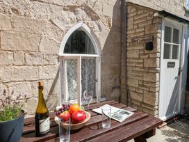 A table with fruit and a bottle outside Driftwood in Weymouth