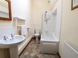 A bathroom with a sink a toilet a bathtub with a shower and a radiator at Beechwood Wood Norton near Foulsham