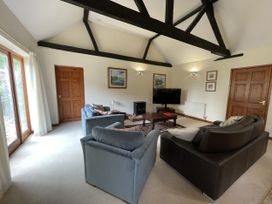 A living room with sofas and a television at Beechwood in Wood Norton near Foulsham