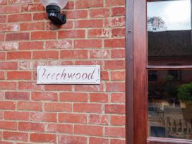 A brick wall with a nameplate reading Beechwood at Beechwood in Wood Norton