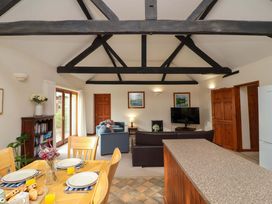 A living room with a dining area and furnishings at Beechwood in Wood Norton